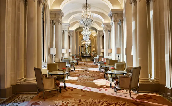 La Galerie dining room corridor with its chandeliers and set up tables, at Hotel Plaza Athénée, Paris