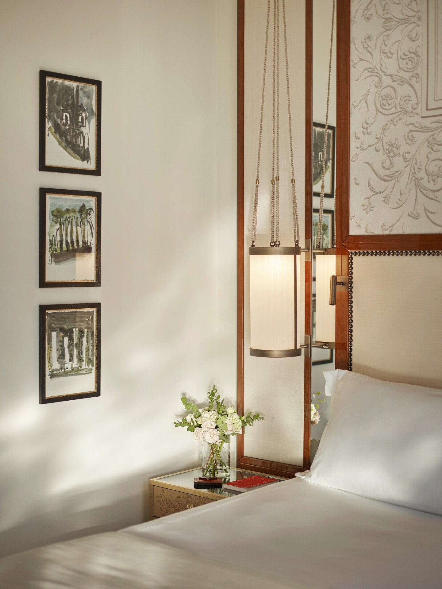 Bedroom detail of Prestige Suite with bouquet of flowers on night table at Hotel Eden, Rome