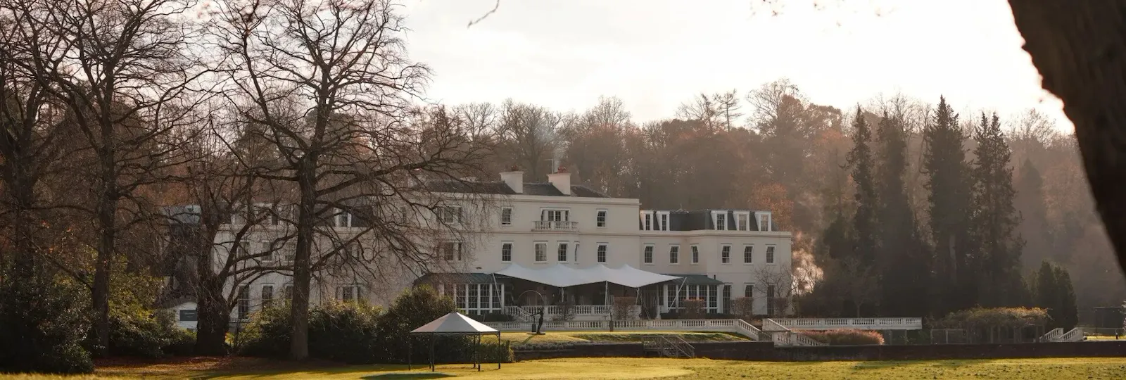 The exterior of the Mansion House at Coworth Park in the evening light