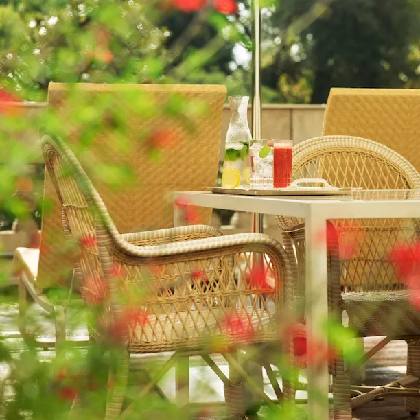 View of Principe Suite terrace with details of flowers and a table with chair