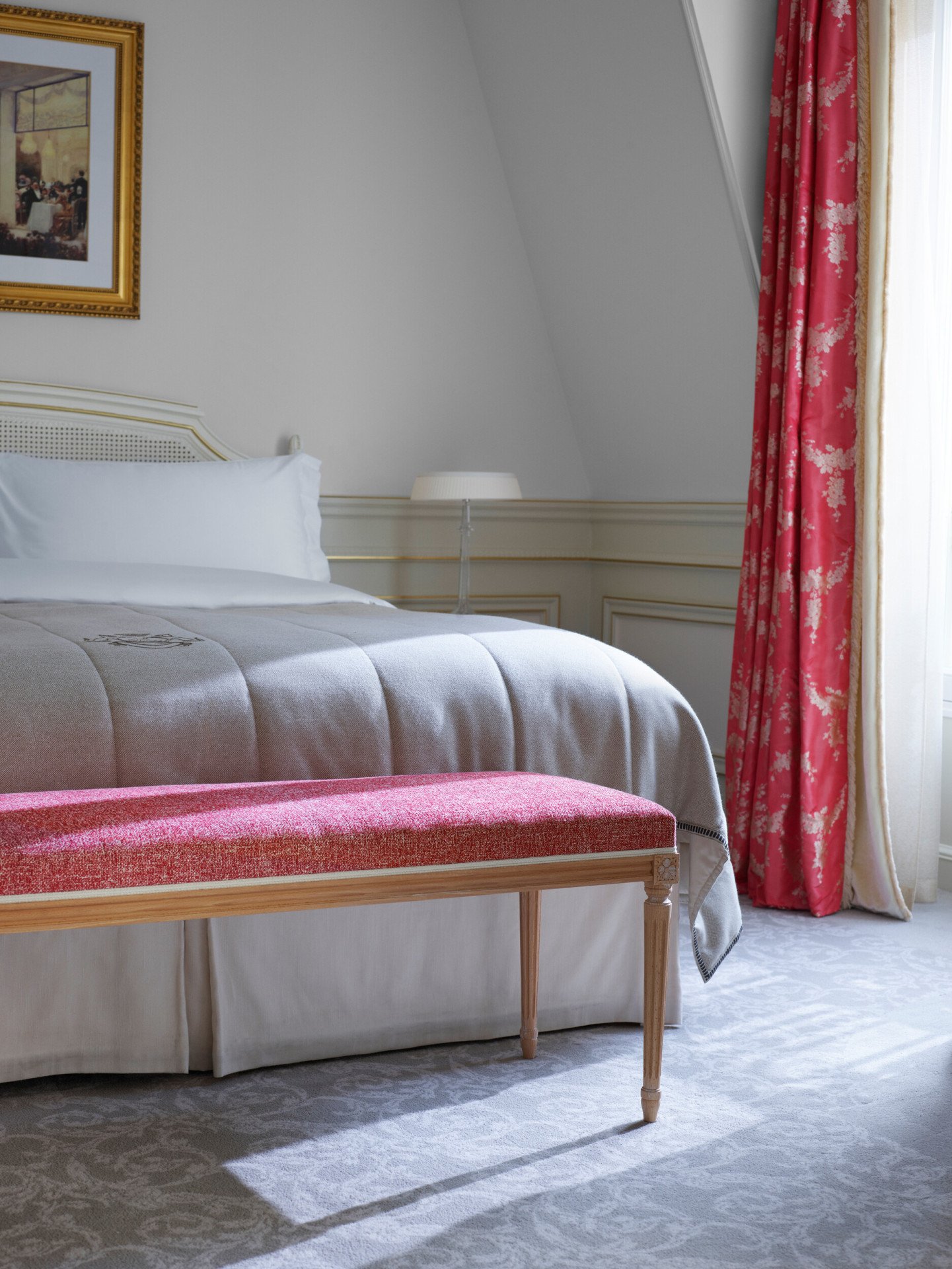 Closeup of bed and bench in front in the bedroom of an executive junior suite at Le Meurice, Paris.