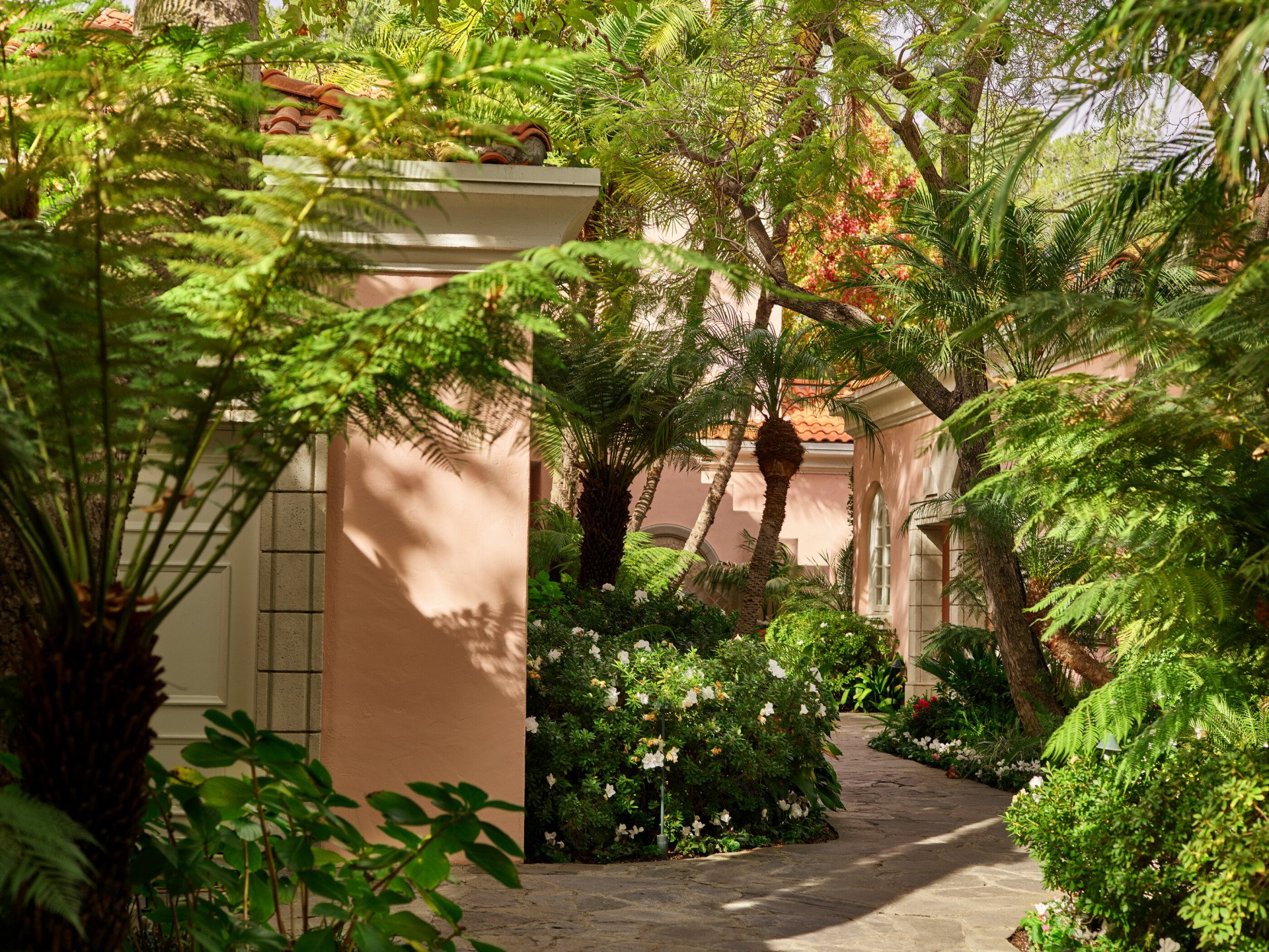 Garden pathways lead to rooms, suites and fountains