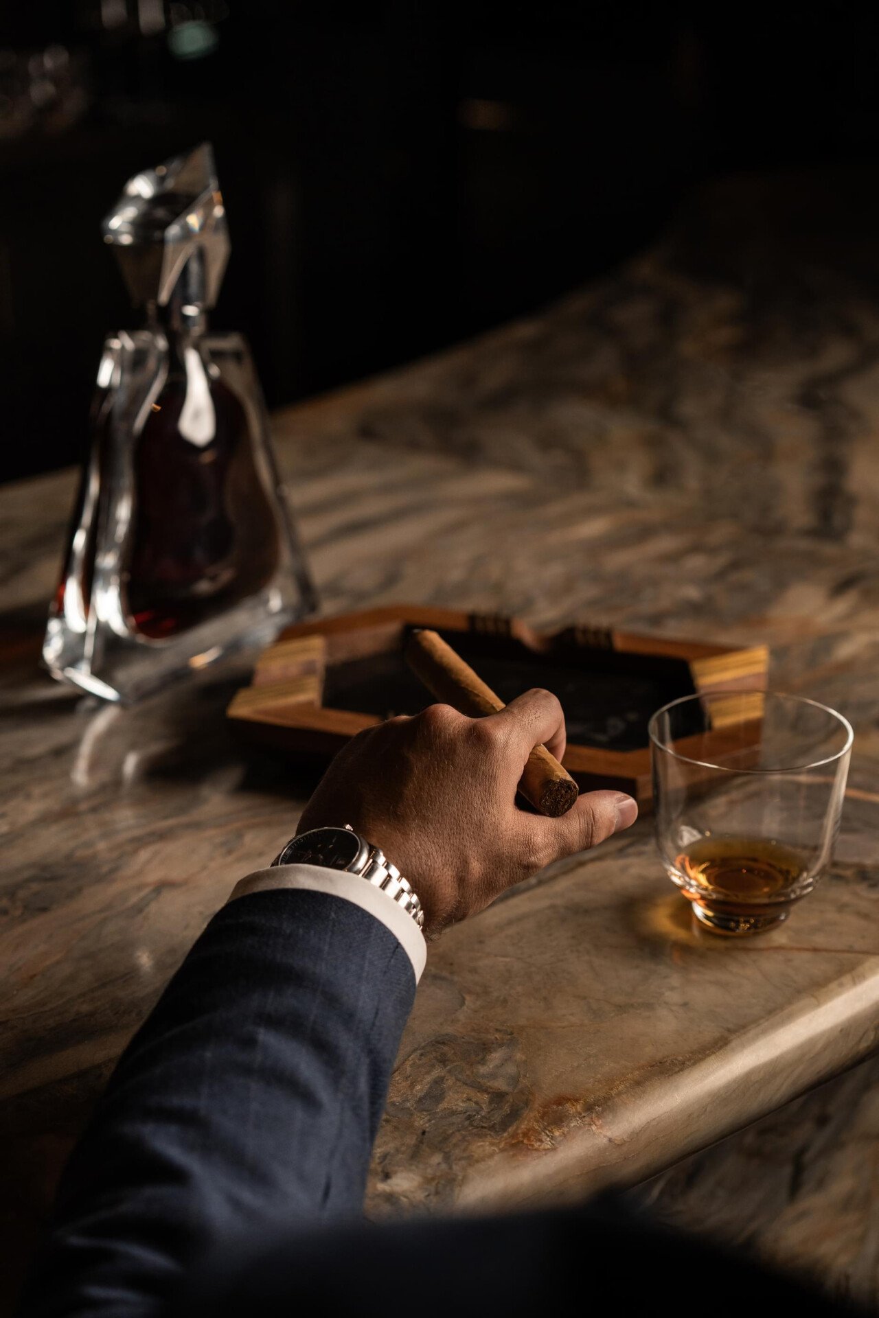 Images depicting Txakolina bar details at The Lana, Dorchester Collection, Dubai, including cigar, drink offerings and vinyl.