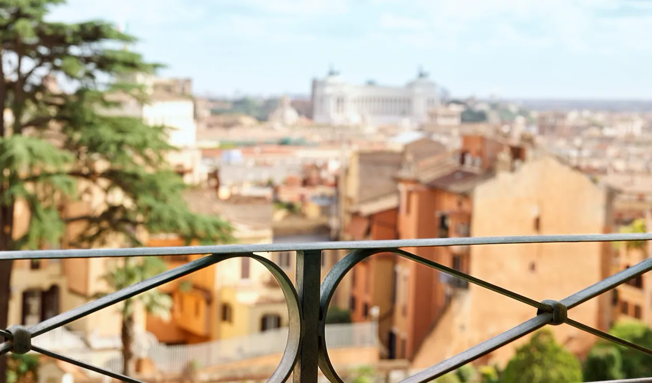 Balcony railing of Classic suite with view at Hotel Eden with view of Rome in the background