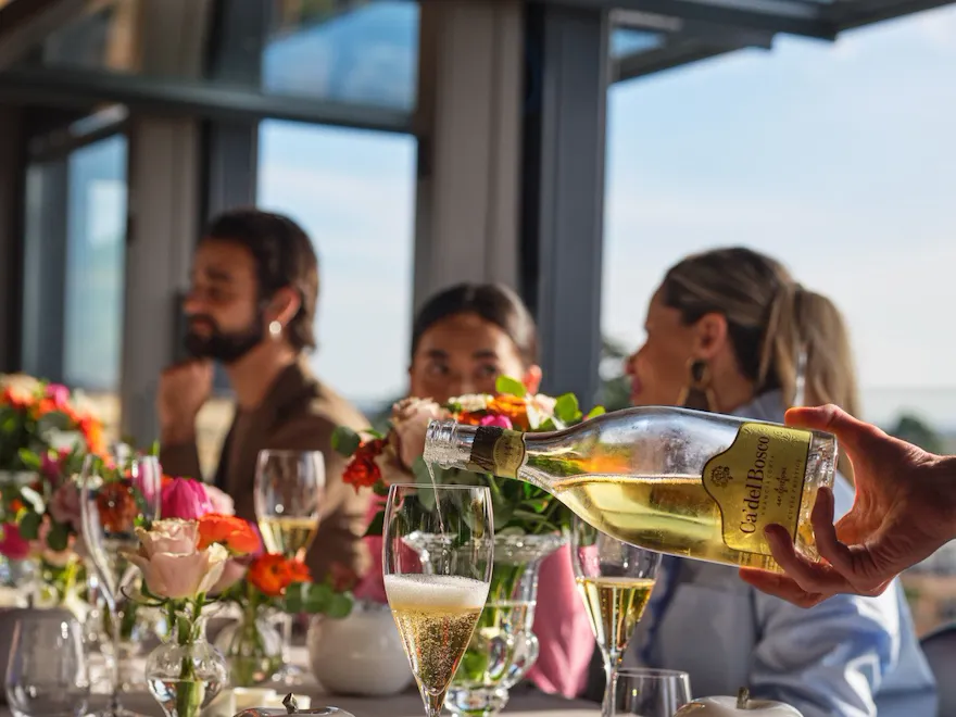 Waiter serving prosecco at La Terrazza
