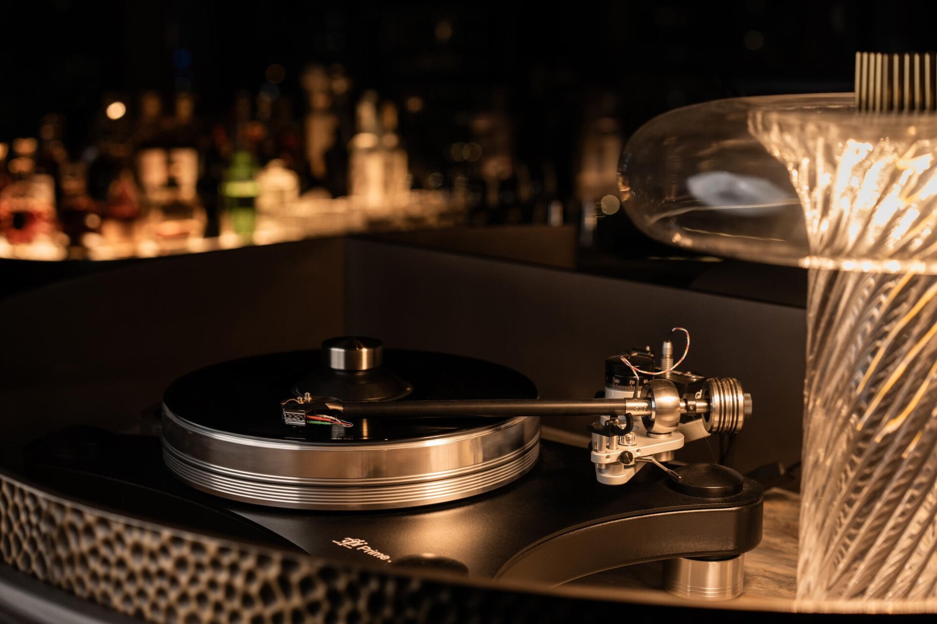 Images depicting Txakolina bar details at The Lana, Dorchester Collection, Dubai, including cigar, drink offerings and vinyl.