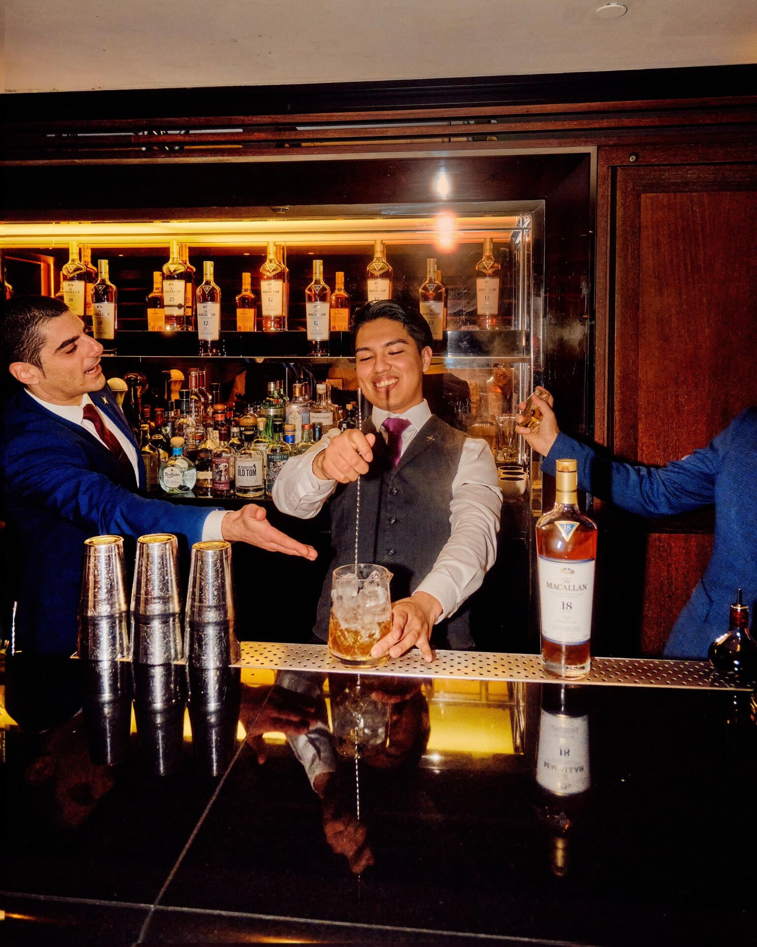 The Macallan Party at 45 Park Lane guests having a great time at night in Bar 45 with bartenders making cocktails