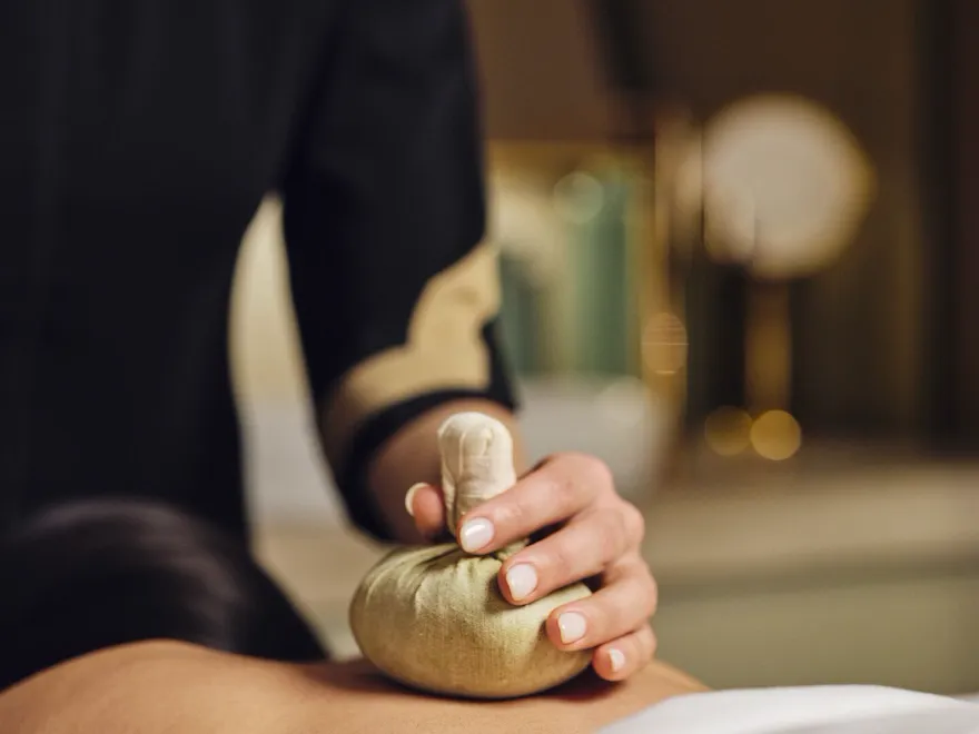 Spa therapist who is actively doing a hay treatment by Hobepergh