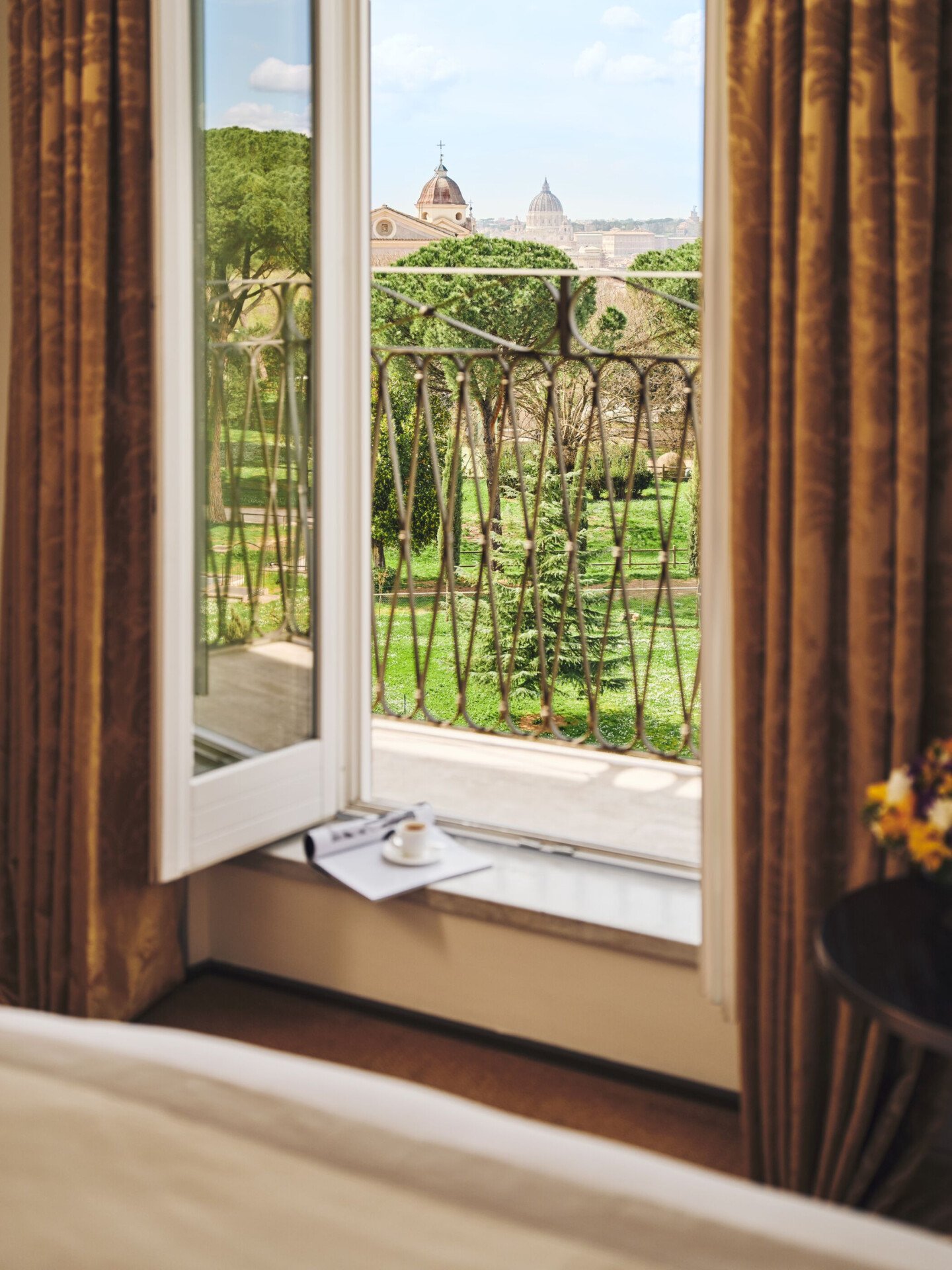 Cap of coffee and magazine on a balcony with view over Rome at Hotel Eden
