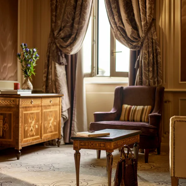 Ambassador Suite Living Room Detail of a brown bag on the floor matching the colours of the pieces of furniture