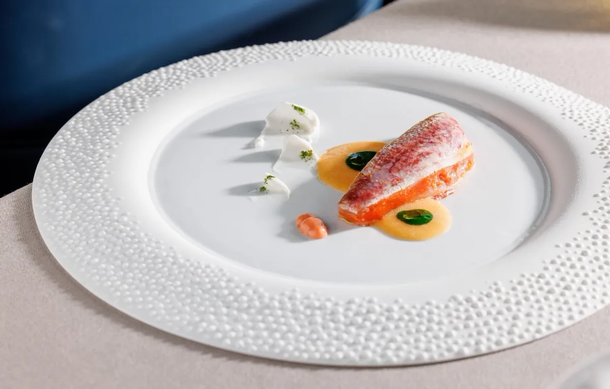 Fillet of red mullet with different sauces on a plate