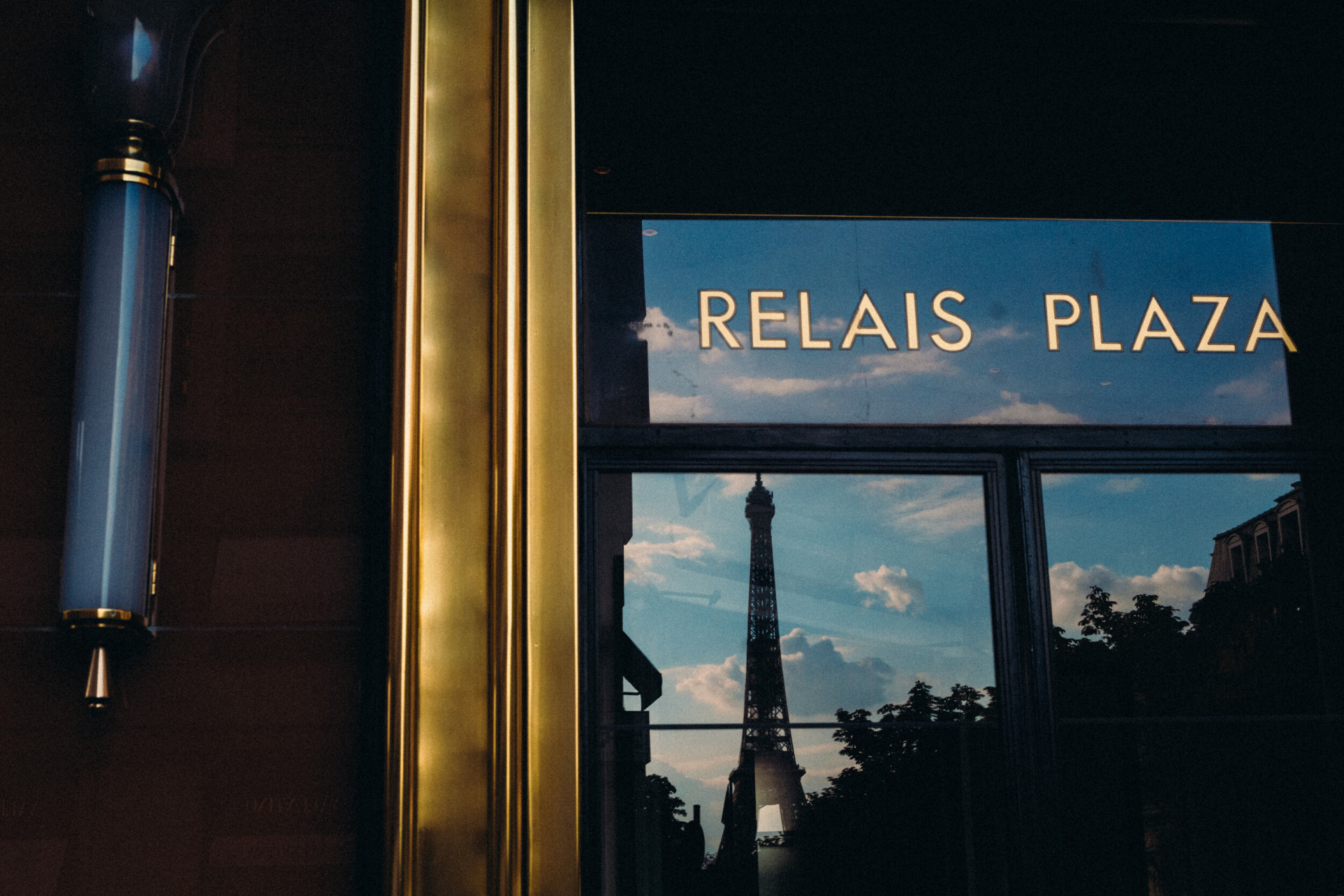 Eiffel tower reflection in the window of Le Relais Plaza, at Hotel Plaza Athénée, Paris