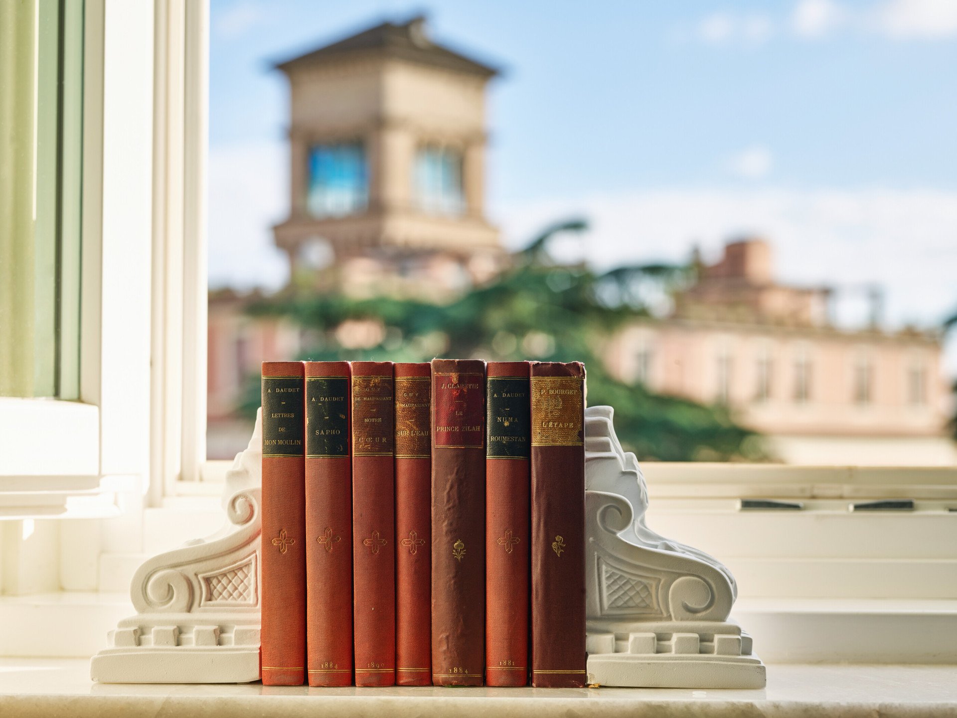 Books and view of Rome in the background at Junior Suite at Hotel Eden, Rome
