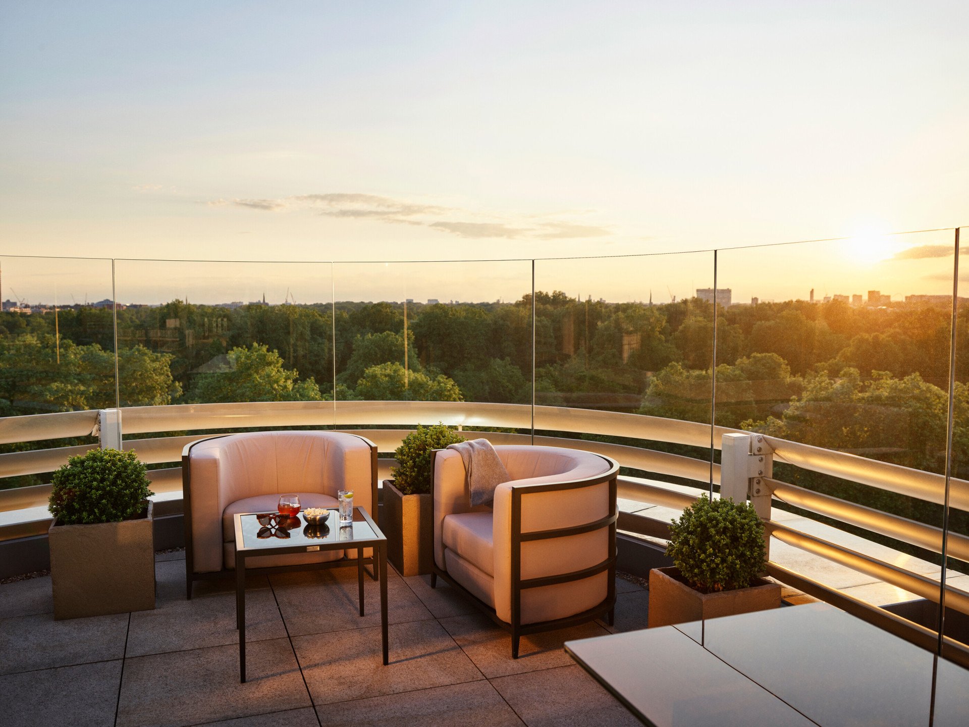 The Penthouse terrace with views of Hyde Park at sunset, at 45 Park Lane, London