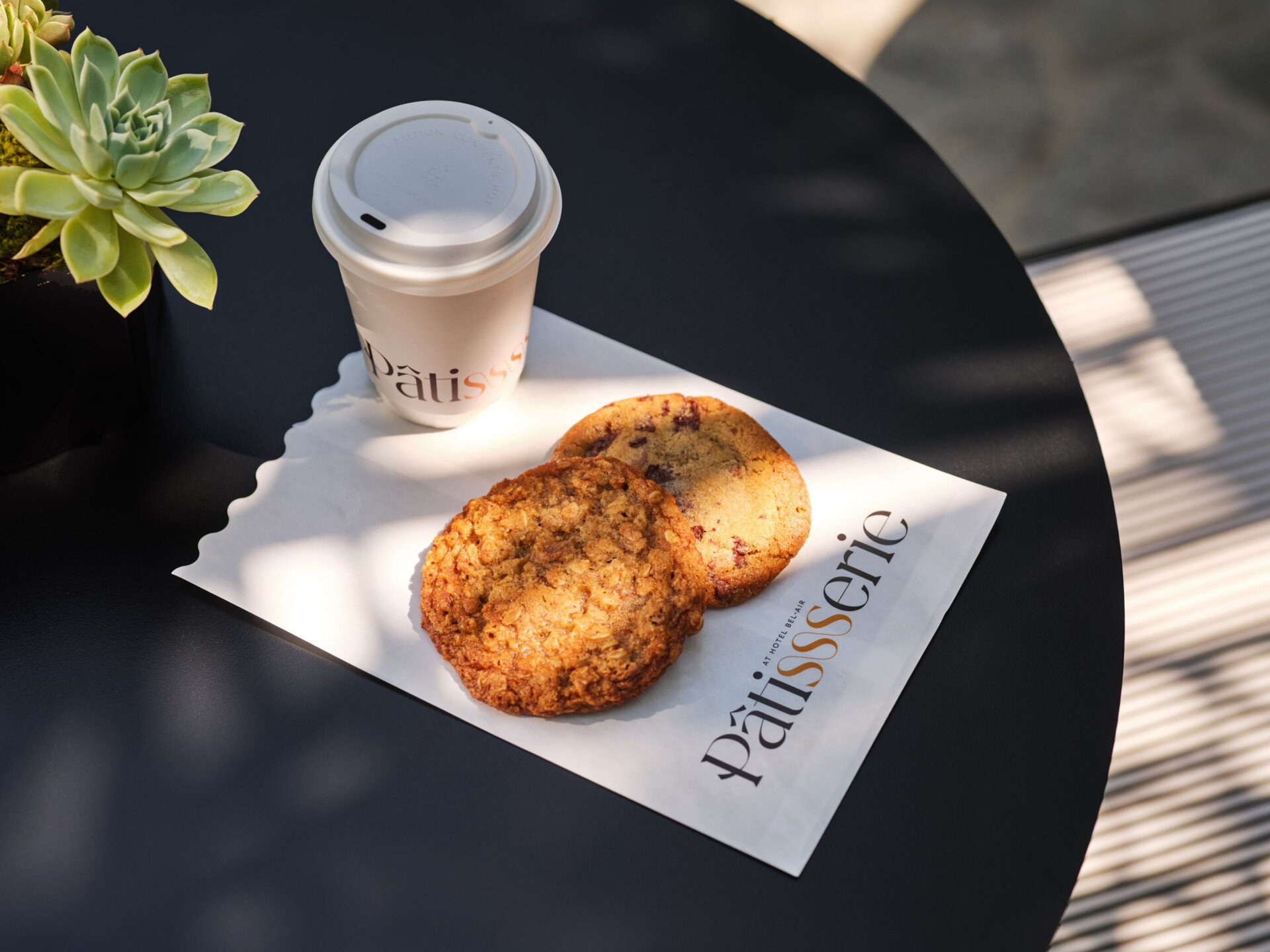 Cookies from The Patisserie on a courtyard table 