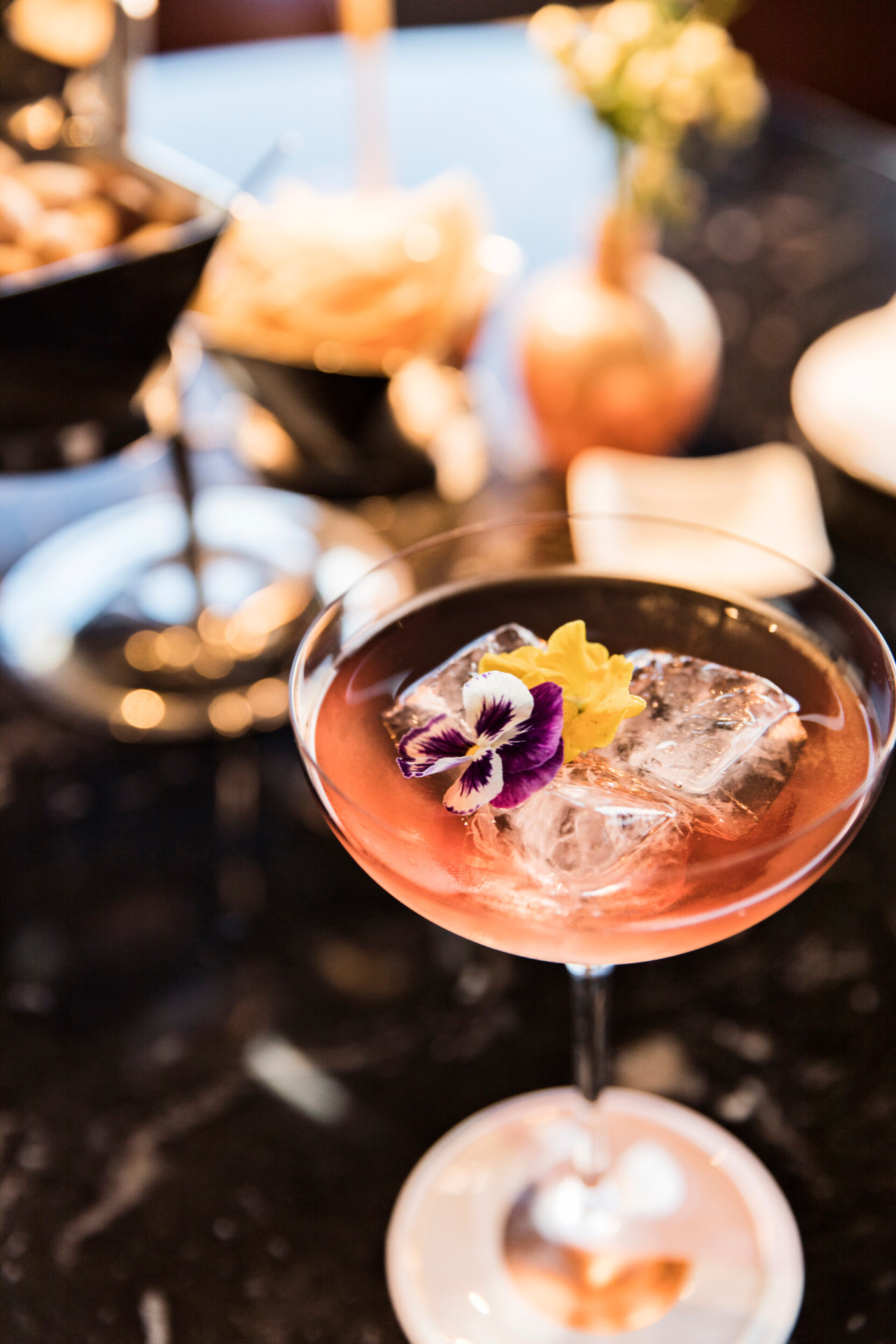 Aperitivo with one drink and nibbles in the background at Il Giardino Bar, Hotel Eden, Roma