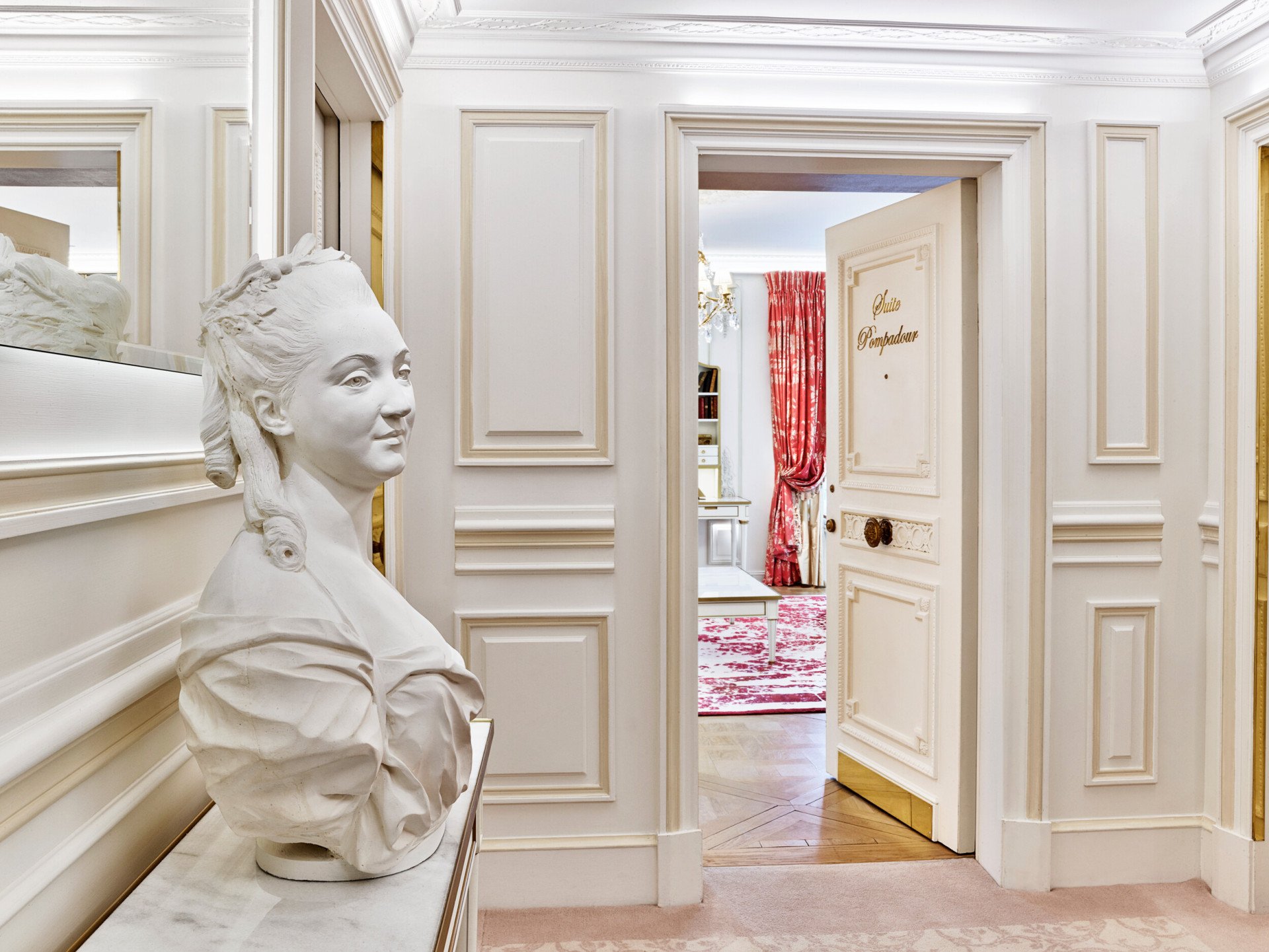 Entrance of the Pompadour suite with a statue at Le Meurice, Paris.
