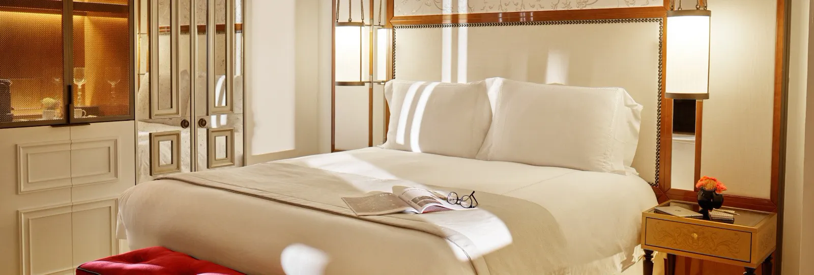 Bedroom of prestige room, headboard with peacocks illustration an mirrored wardrobe, at Hotel Eden, Rome