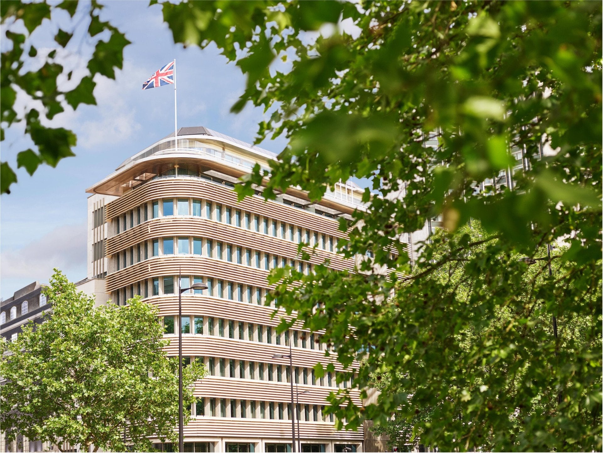 Exterior facade of 45 Park Lane London on a sunny day from Hyde Park, London