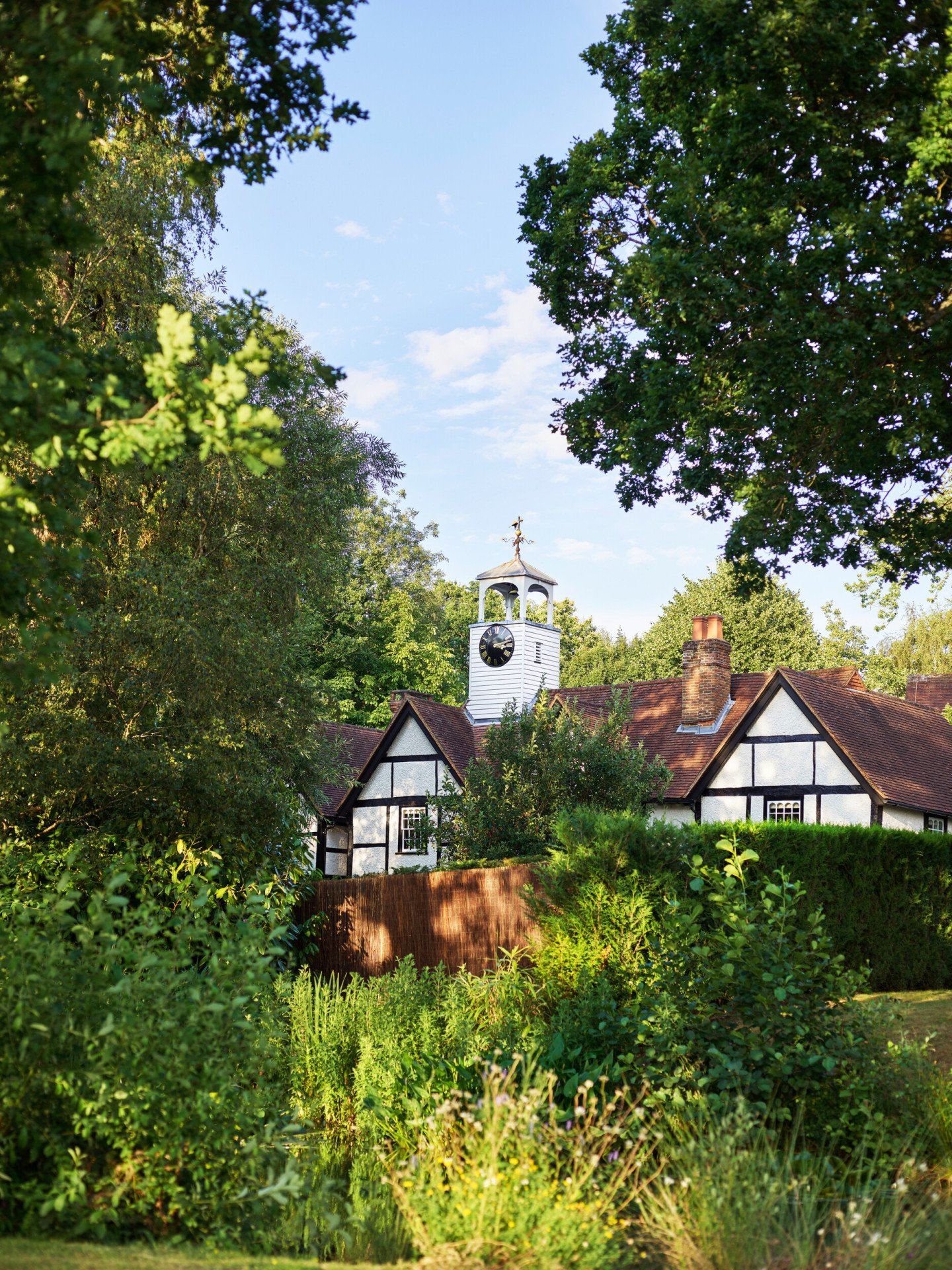 Coworth Park-Dower House - exterior summer garden view form the bridge