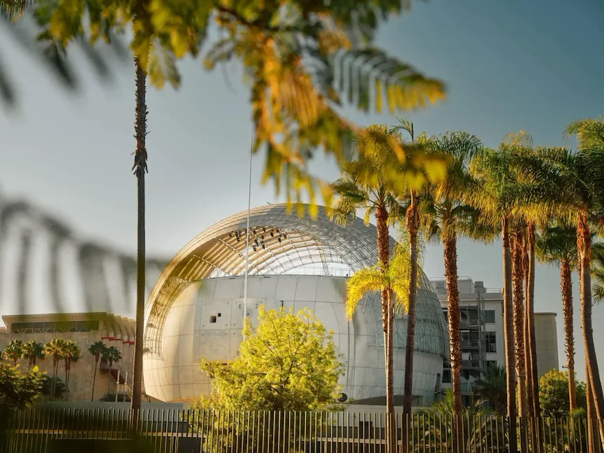 Architectural exterior and palm trees around of the Academy of Motion Pictures Museum in Los Angeles