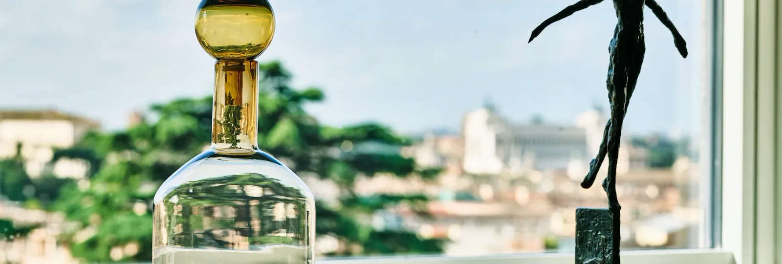 Sculpture and glass vase by the window at Bellavista Penthouse Suite at Hotel Eden, Rome