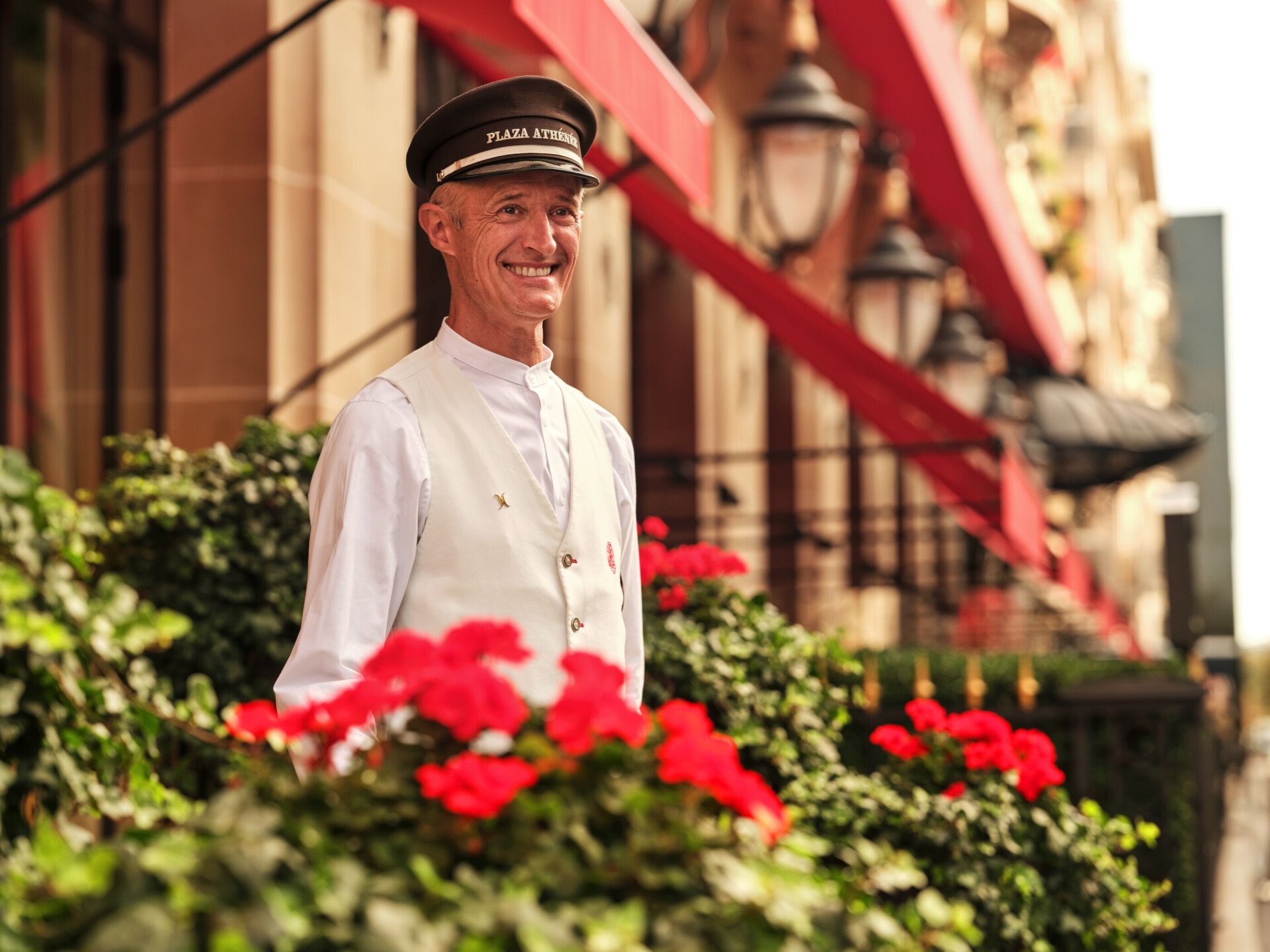 This is a close-up shot of the doorman in front of the entrance of the Plaza Athénée. 