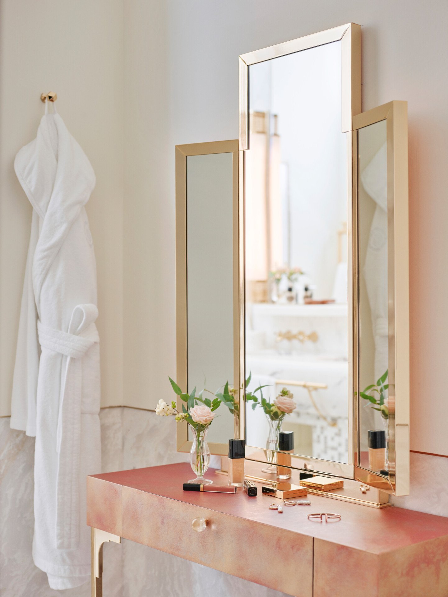 Vanity table with makeup products and bathrobe inside bathroom of Prestige suite at Hotel Eden, Rome