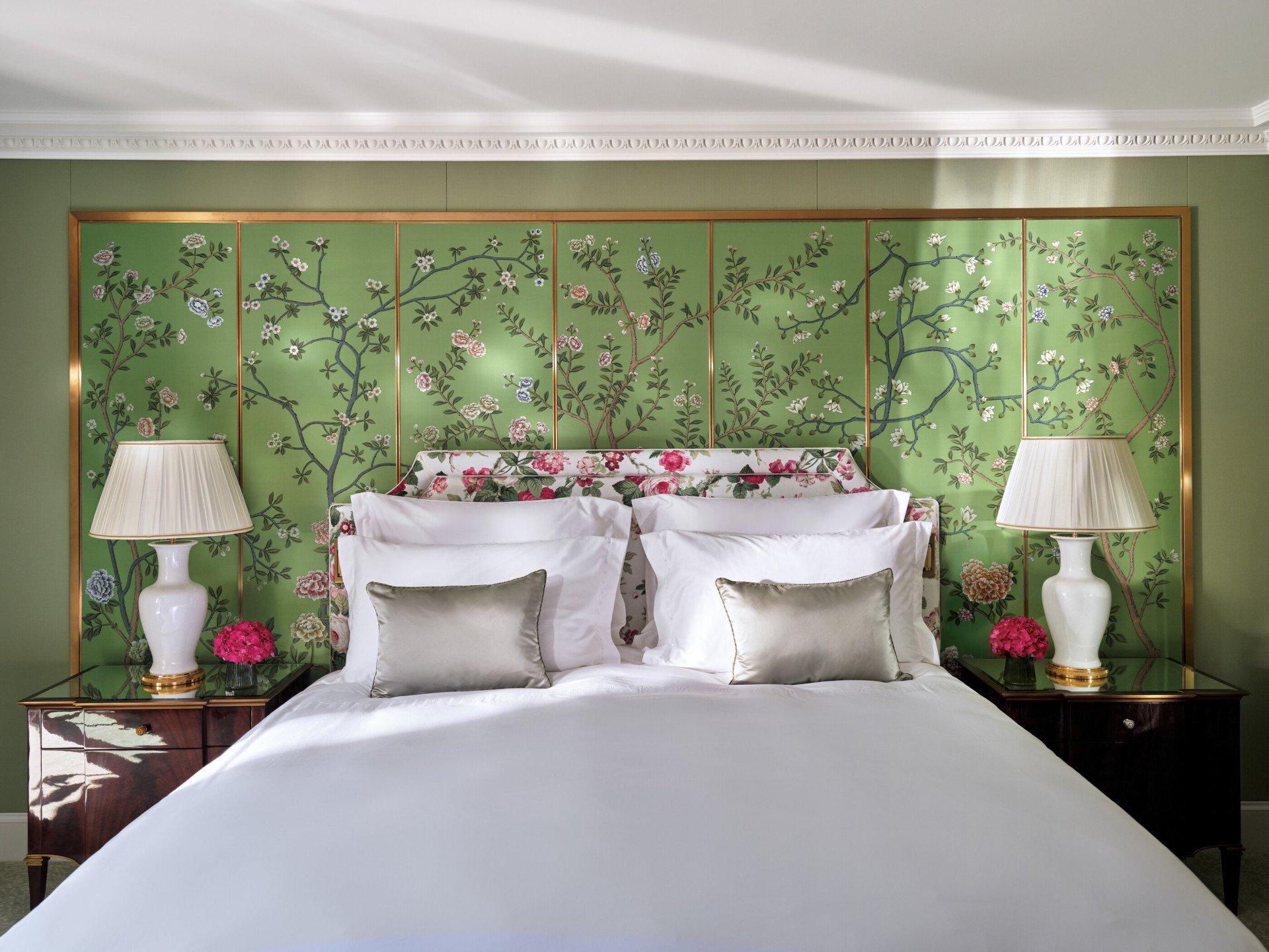 The Belgravia Suite bedroom with green walls and pink floral wall details
