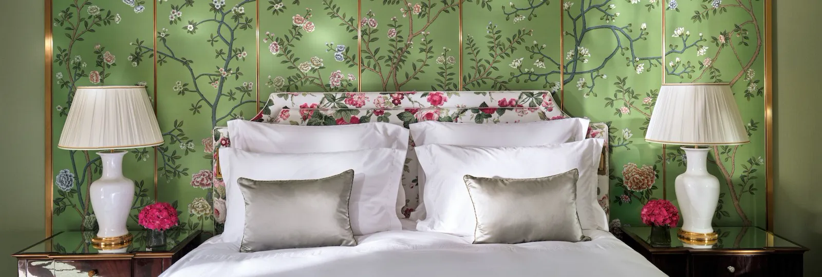 The Belgravia Suite bedroom with green walls and pink floral wall details