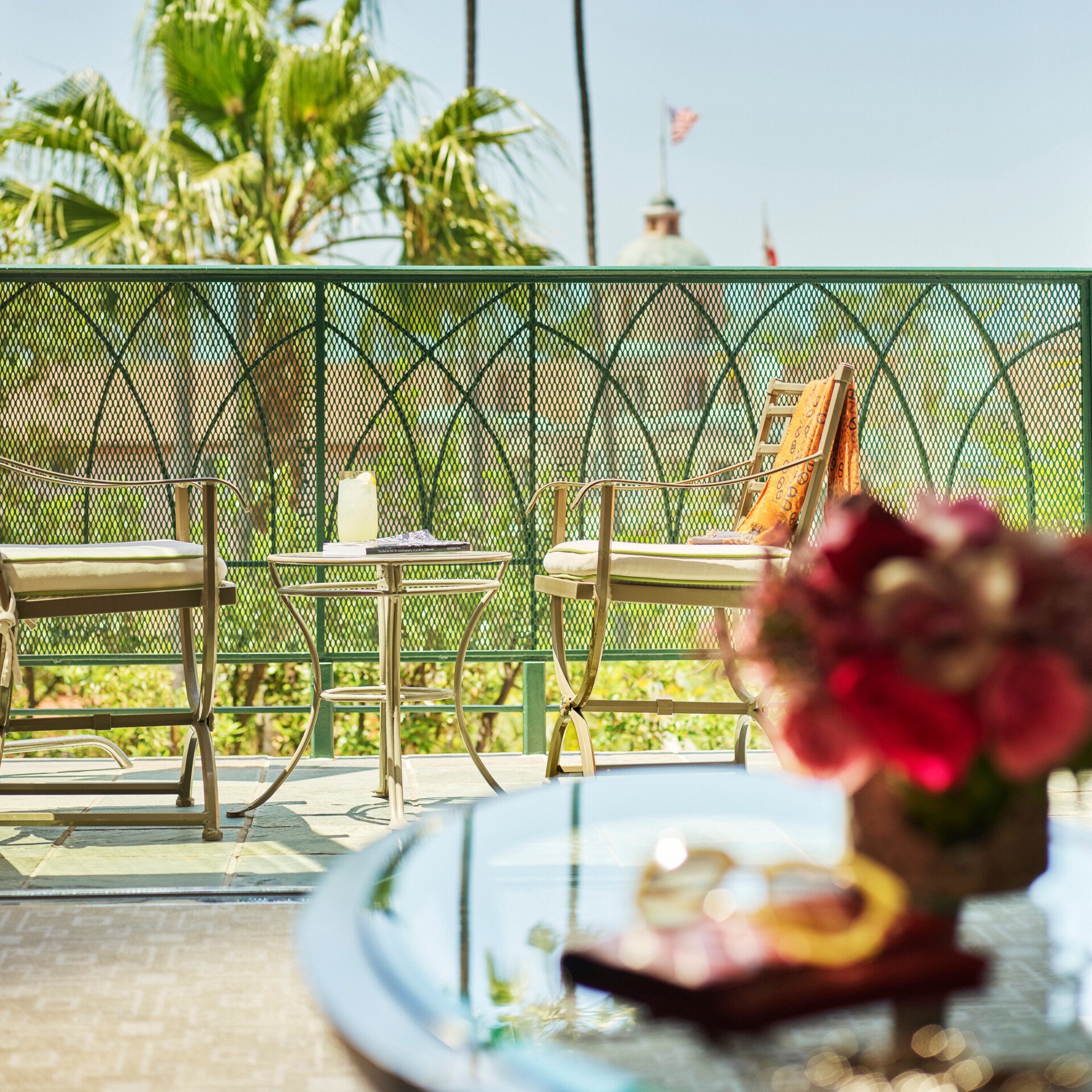 Table and chairs set up on balcony of deluxe guestroom in Beverly Hills