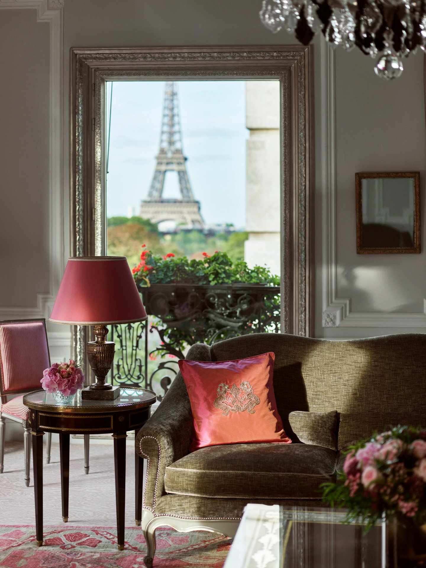 Haute Couture Suite Living room with balcony doors open to view of Eiffel Tower