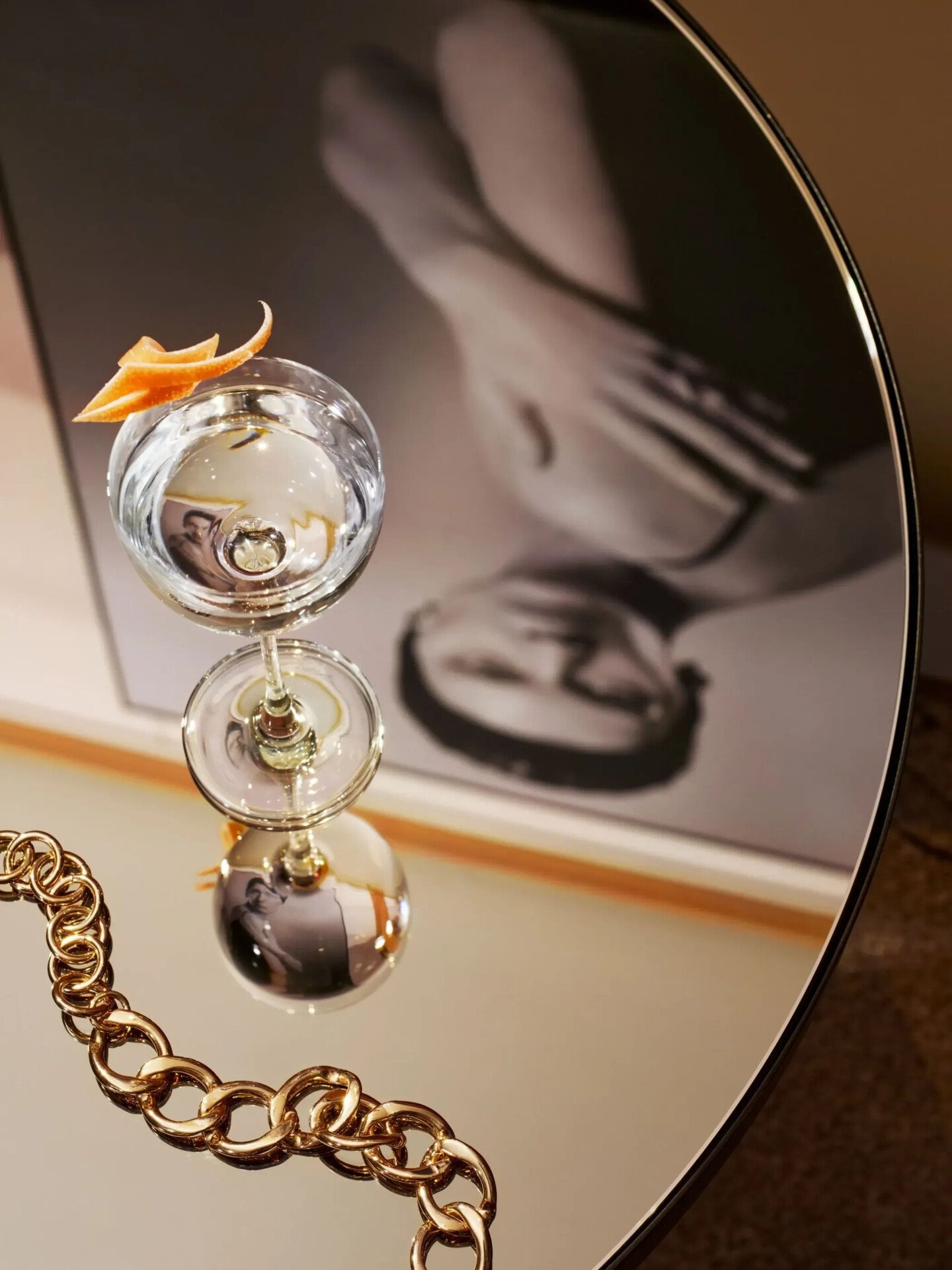 Close up on one of the tables in Il Salotto Lobby Lounge with a cocktail and the reflection of a hanging black and white picture 