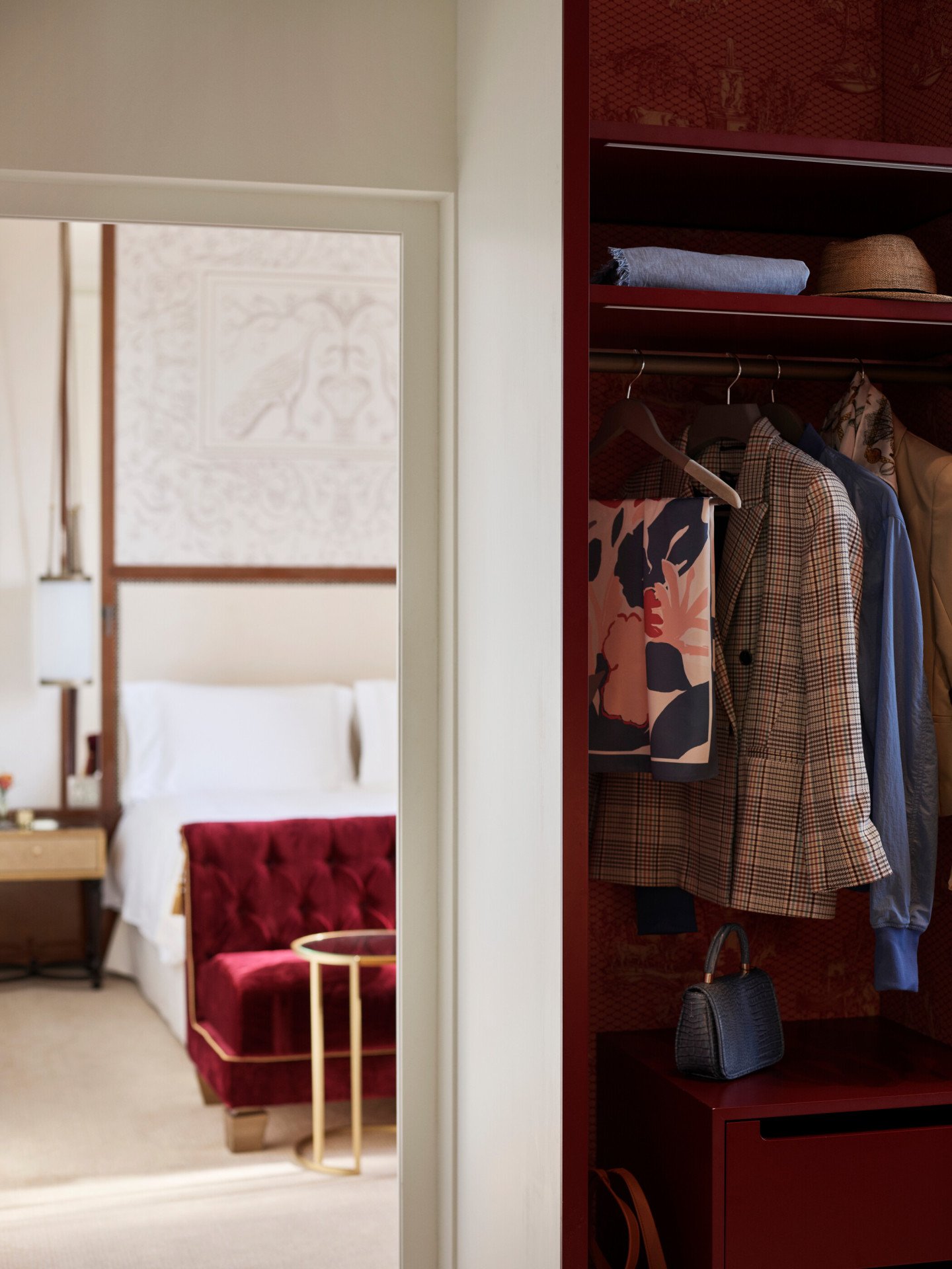 Wardrobe with clothes and bedroom in the background at Dolce Vita Suite at Hotel Eden, Rome