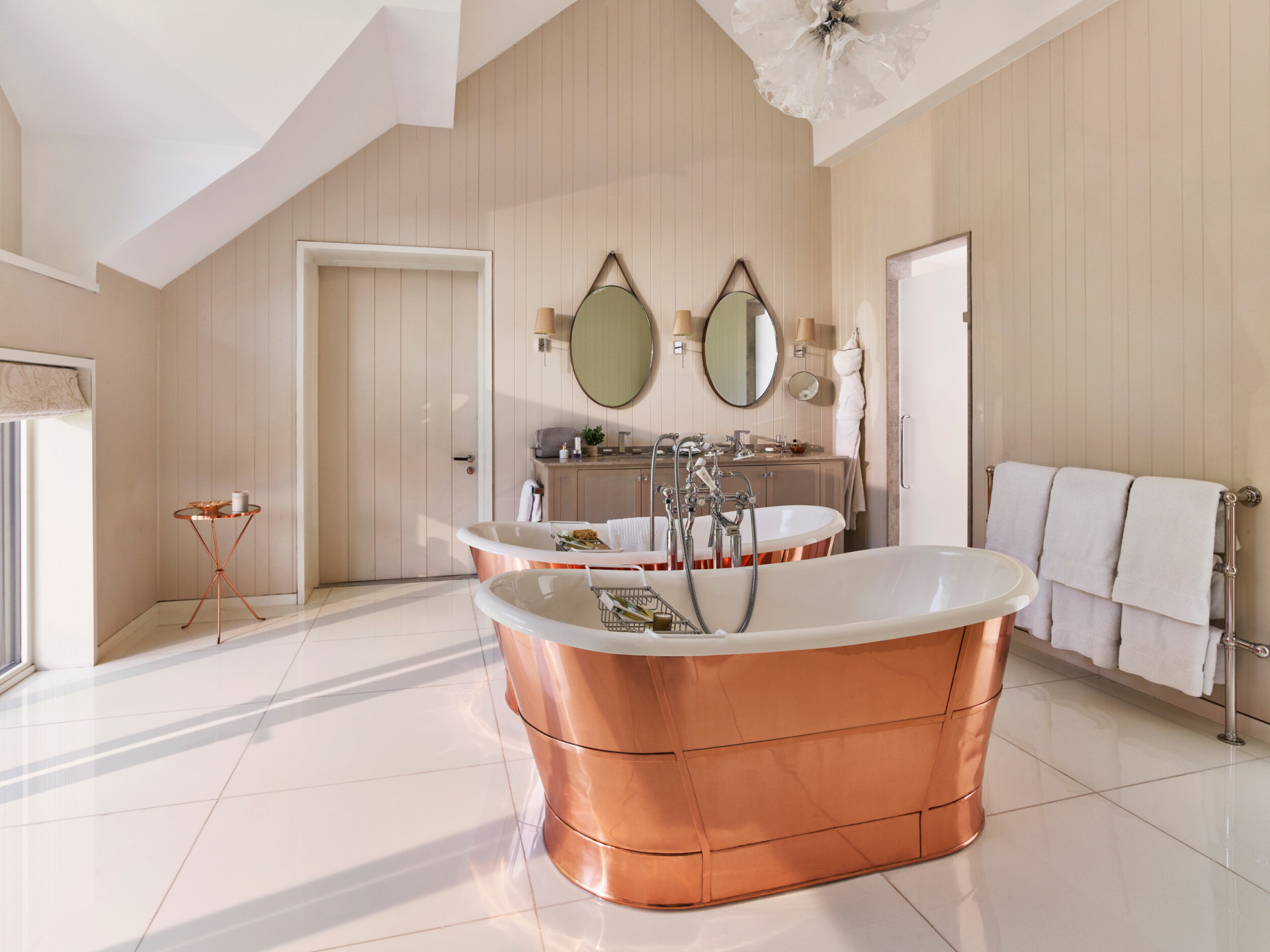 Coworth Park-Stable Premium Suite- bathroom with double copper roll top baths 