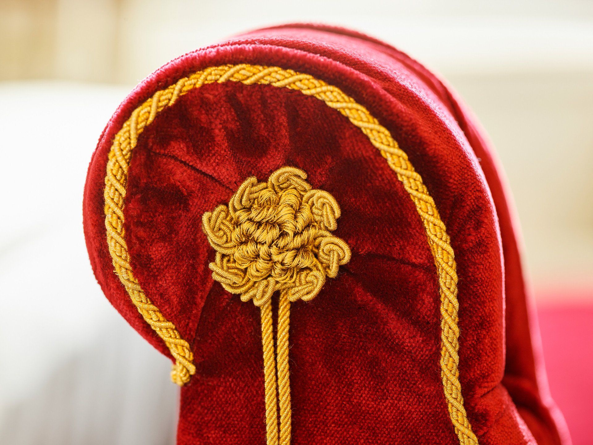 Red couch with golden details at Dolce Vita Suite at Hotel Eden, Rome