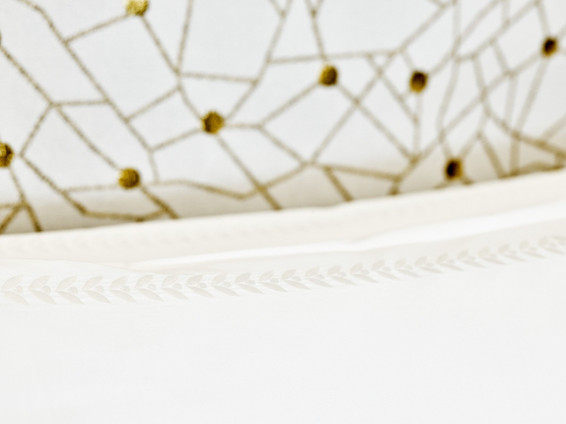 Detail of pillow with laurel leaves embroidery at Bellavista penthouse suite at Hotel Eden, Rome