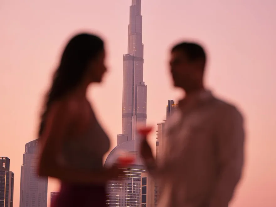 A couple enjoying drinks with the view of Burj Khalifa.