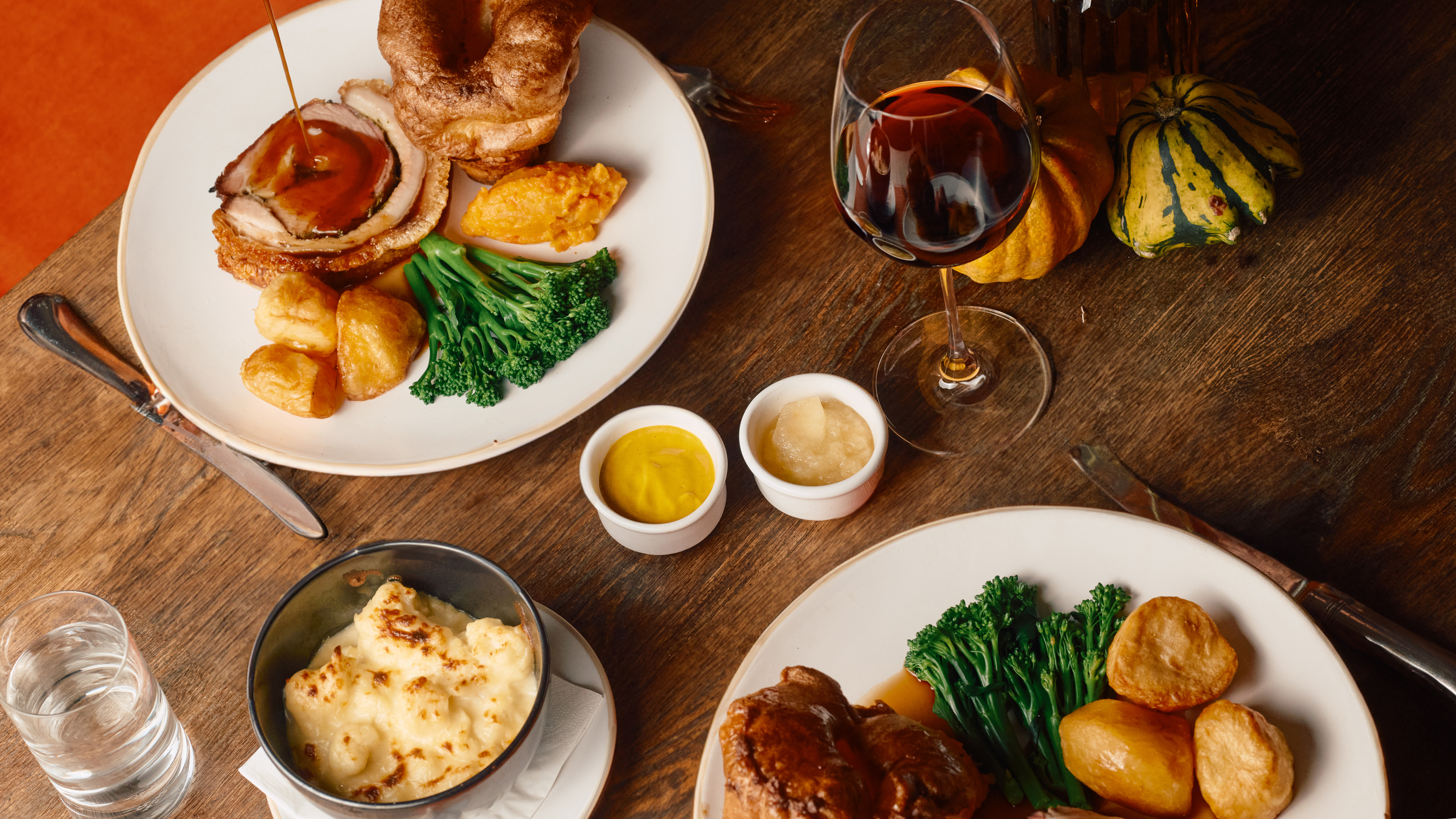 Sunday lunch at The Barn at Coworth Park featuring roast, wine and sides.
