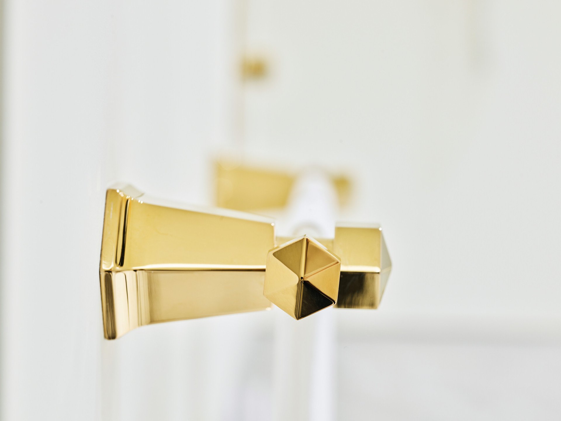 Detail of gold towel hanger with white marble background at Classic Suite at Hotel Eden, Rome