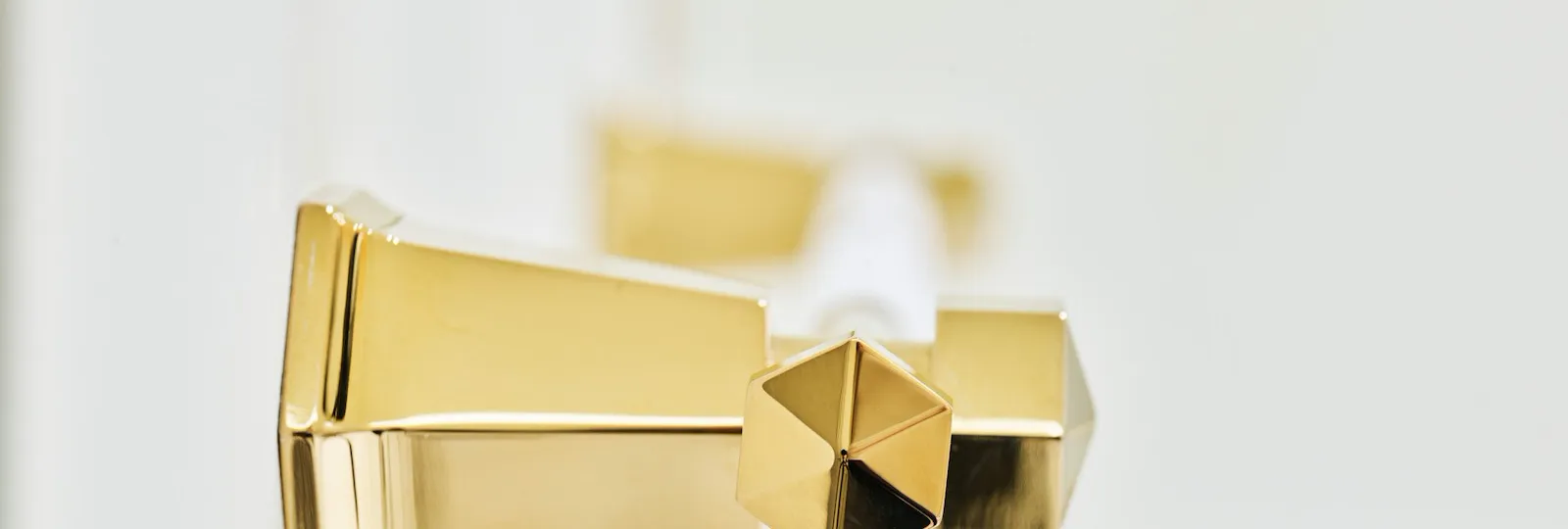 Detail of gold towel hanger with white marble background at Classic Suite at Hotel Eden, Rome