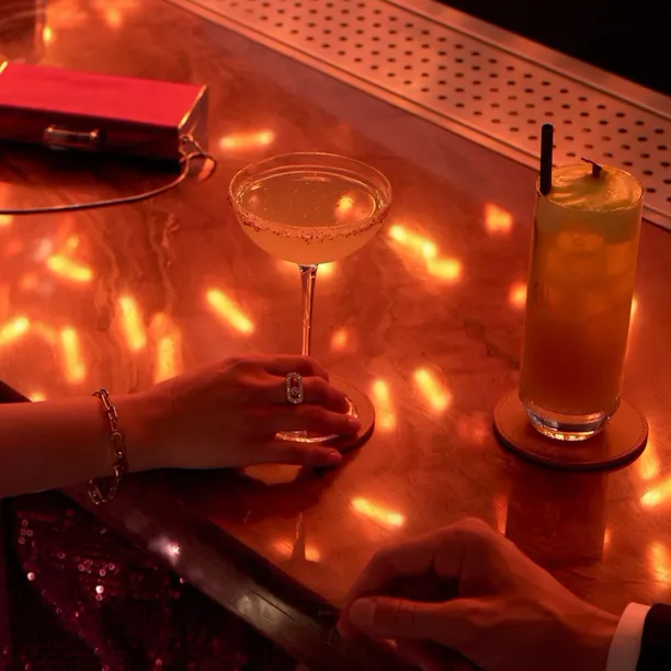 People drinking cocktails in the bar of Jara by Martin Berasategui