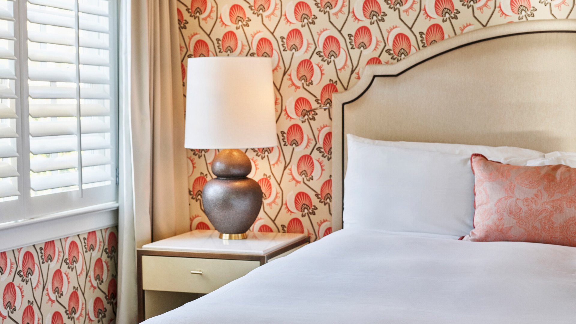 Corner of bed and deskside table in Bungalow Patio Room, The Beverly Hills Hotel 