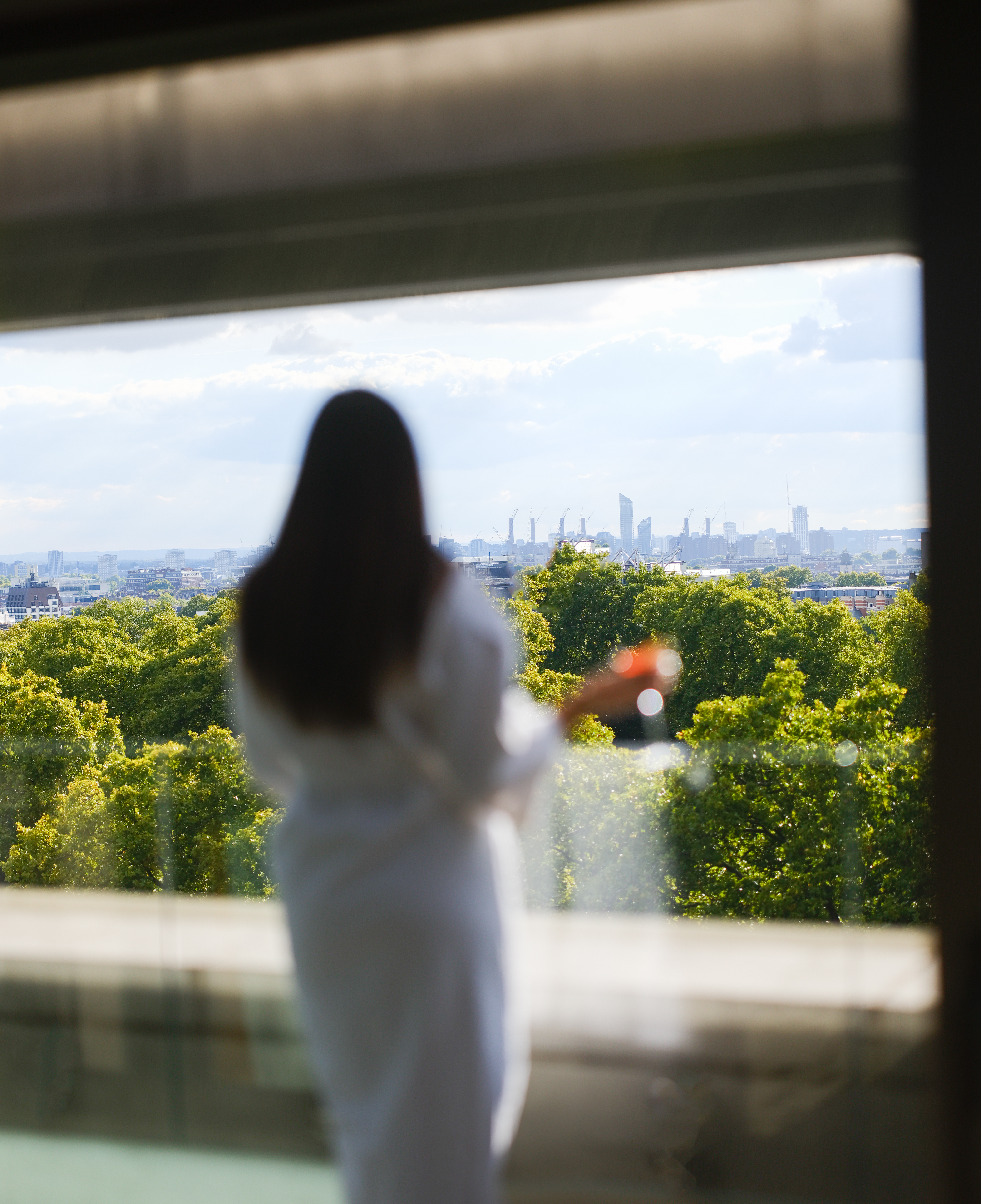 Lady looking over Hyde Park from suite 
