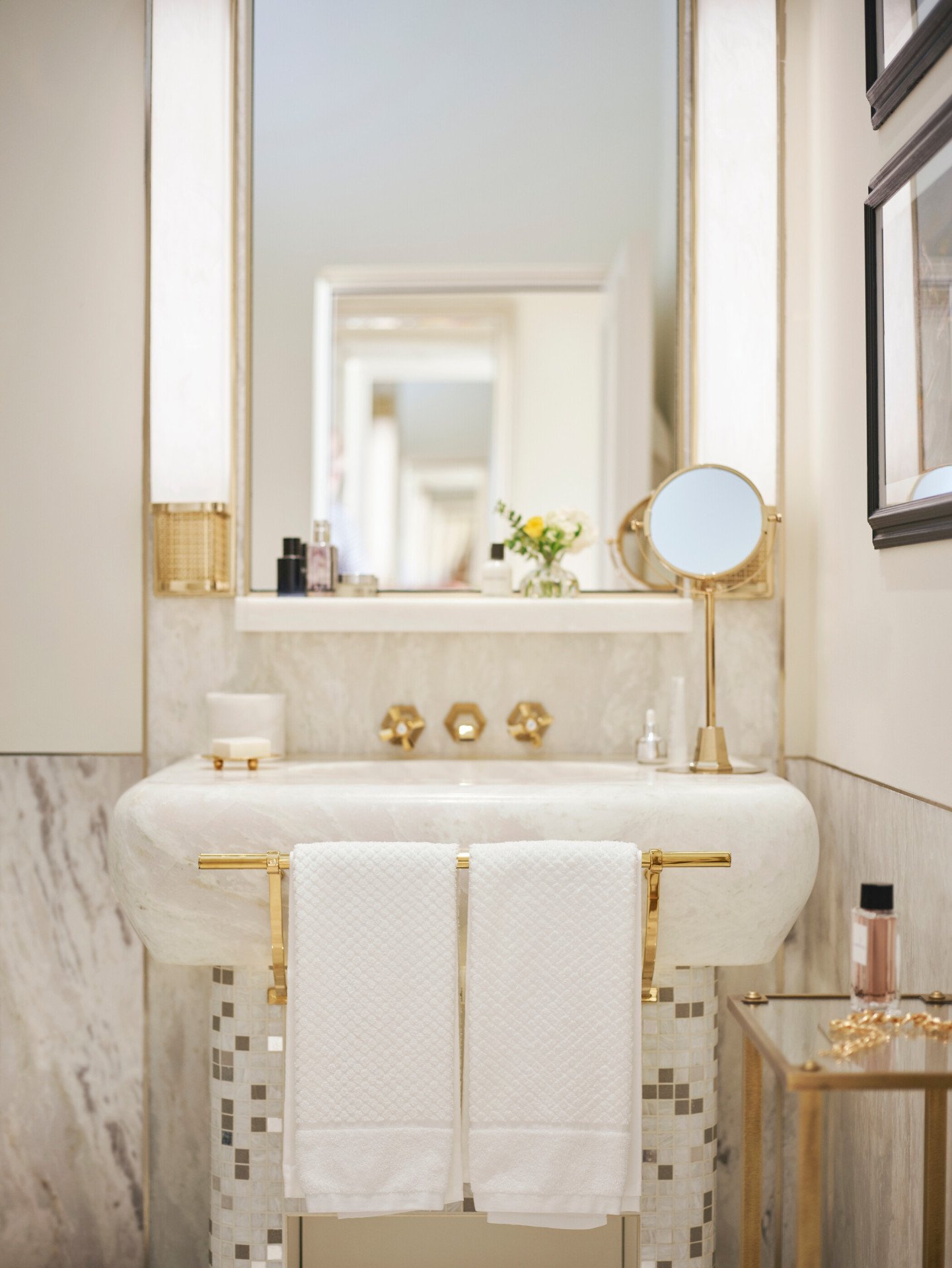 Bathroom of Classic Suite with white marble sink, towels and mirror at Hotel Eden, Rome